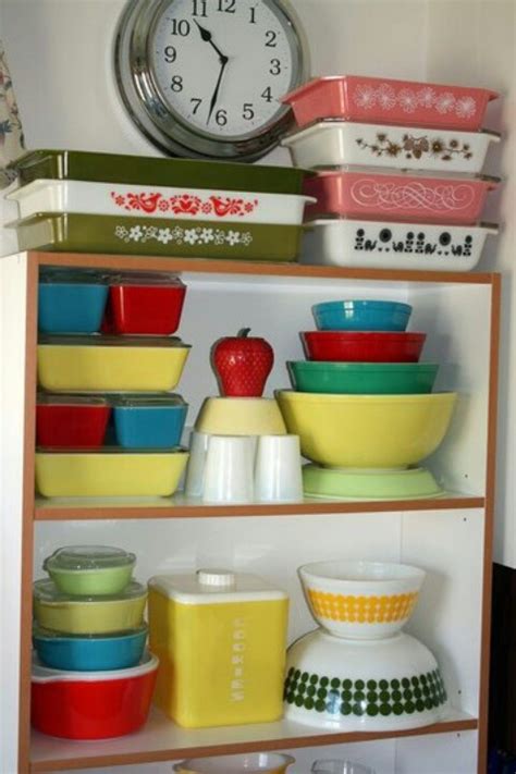 A Shelf Filled With Lots Of Different Colored Bowls And Containers Next