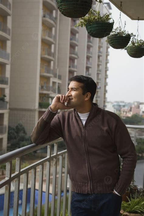 Man Standing On A Balcony Thinking Photo Background And Picture For