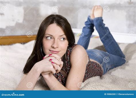 Smiling Woman In Jeans Lying On Sofa Stock Photo Image Of Indoor