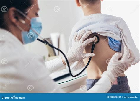 Doctor Listening To Boy S Chest With Stethoscope Stock Image Image Of