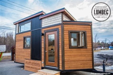 The living room, which is unfurnished, sits by the doorway at the opposite end of the home's bathroom, bedroom, and kitchen. 136 Sq. Ft. Lumbec Tiny House on Wheels