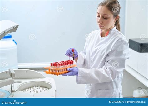 Doctor Holding Test Tube Examining Human Centrifuged Blood Sample Stock