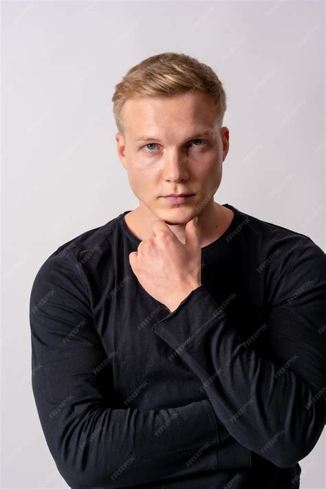 Premium Photo Attractive Blond German Model In A Black Sweater On A White Background Posed In
