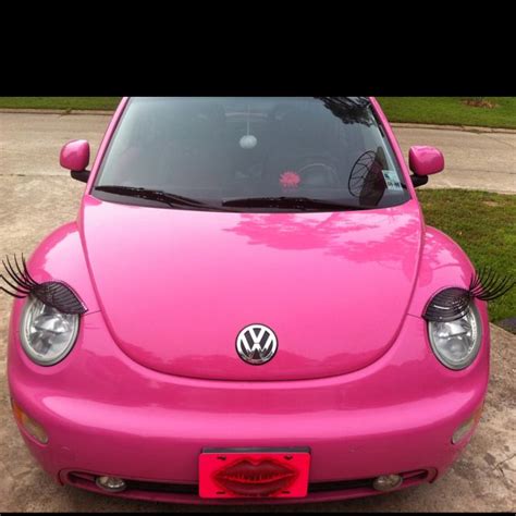 pink volkswagen beetle with eyelashes