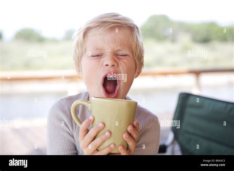 Young Boy Drinking From A Coffee Mug Stock Photo Alamy
