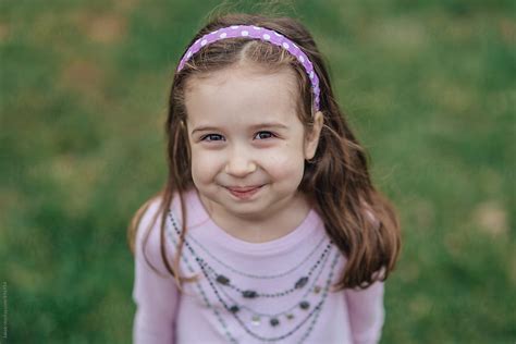 Portrait Of A Cute Young Girl Looking Up At The Camera By Stocksy Contributor Jakob