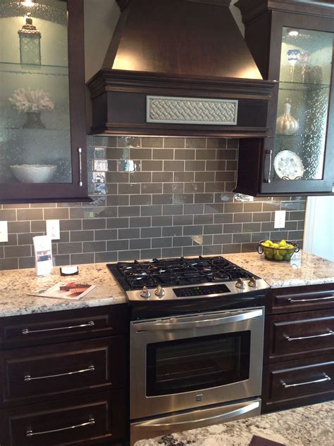 Ice Gray Glass Subway Tile Backsplash With Dark Brown Cabinets And