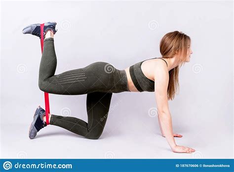 Young Sportswoman Doing The Exercises On All Fours Arching Back