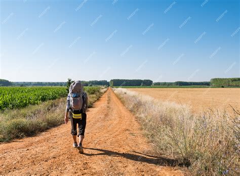 Premium Photo Lonely Pilgrim With Backpack Walking The Camino De