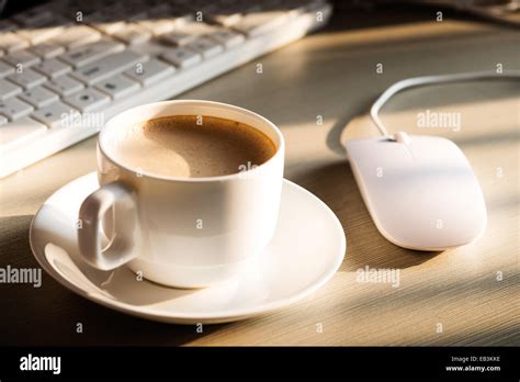 Close Up Of The Coffee Cellphone Pen And A Cup Of Keyboard On The