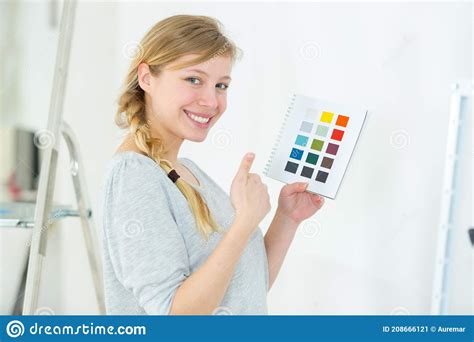 Woman Selecting Home Interior Paint Color From Swatch Catalog Stock