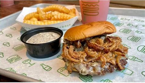 A Close Up Of A Sandwich And Fries On A Tray