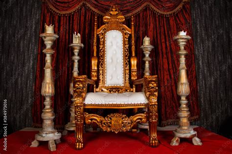Old White And Gold Royal Chair With Red Curtains And Candelabra In