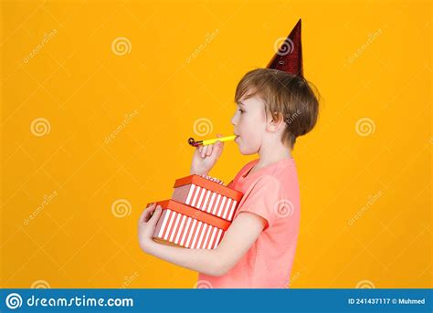 Party Time Joyful Boy In A Festive Cap Celebrates His Birthday Stock