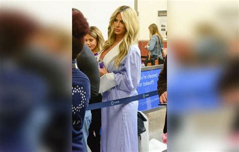 Kim Zolciak Flashes Boobs In Bizarre Robe Outfit At Airport