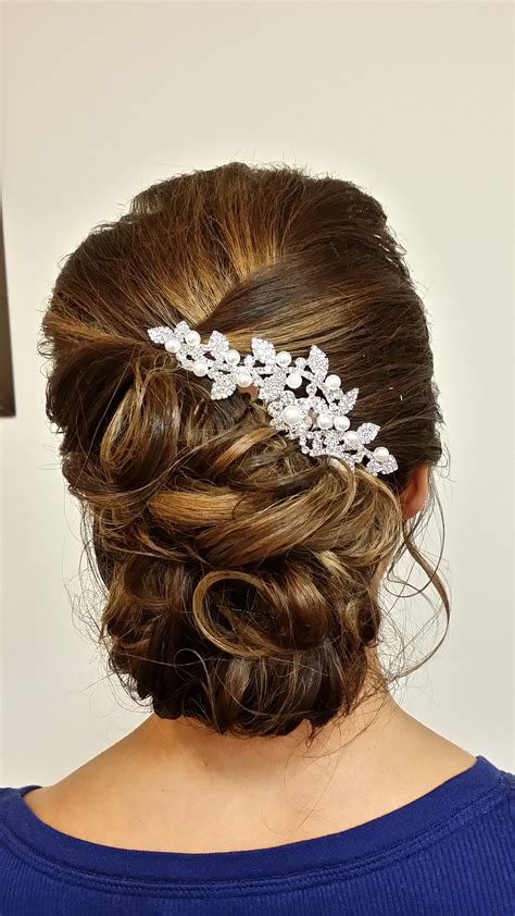 A Classic Curled And Pinned Up Updo Finished With A Bridal Jewelry Accent