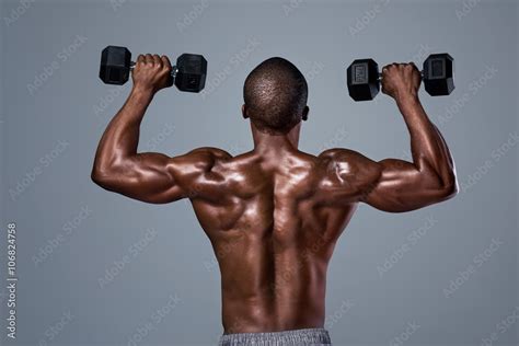 Black Man With Strong Muscular Back Muscles Lifting Weights Stock Photo