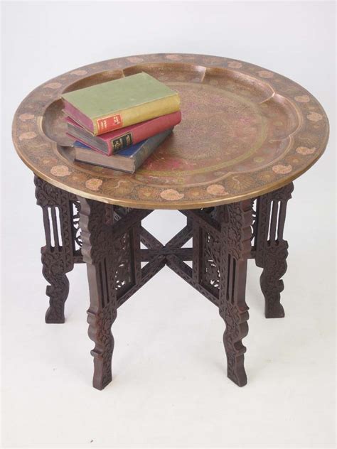 And the dark walnut wood feels warm and welcoming. Benares Brass Tray Table / Coffee Table