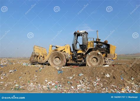 Bulldozer At Landfill For Work Concrete Demolition Waste Salvaging And