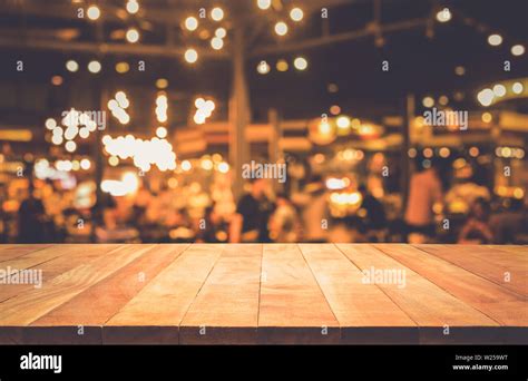 Wood Table Top Bar With Blur Light Bokeh In Dark Night Cafe