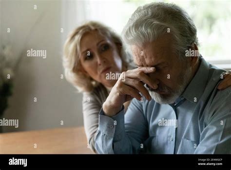 Close Up Caring Mature Woman Comforting Frustrated Husband Hugging