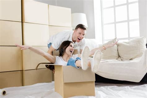 husband and wife have fun unpacking boxes in their new apartment stock image image of house