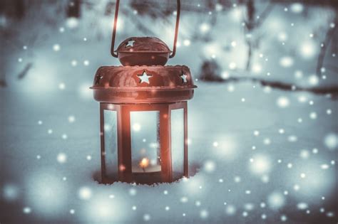 Premium Photo Red Candle Lantern With Candle In Snow During Snowfall