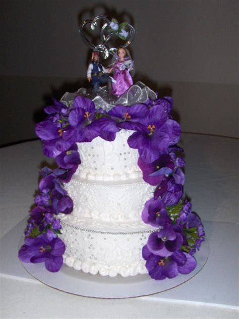 White Wedding Cake With Purple Silk Flowers
