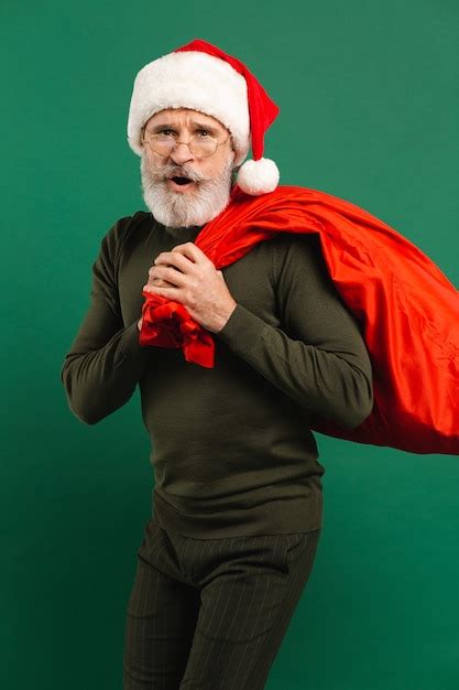 Premium Photo Happy Bearded Modern Santa Claus Holding Red Sack