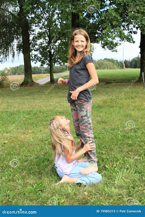 Twee Meisjes Die En Zich Op Elkaar Spelen Bevinden Stock Afbeelding
