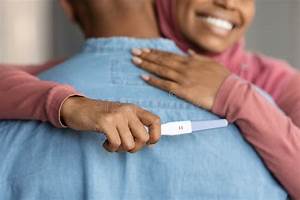 Expecting Baby Black Islamic Woman Hugging Husband And Holding