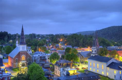 An Aerial View Of A Small Town At Night With The Lights On And