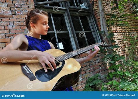 Teenage Girl Playing Acoustic Guitar In The Street Stock Photo Image
