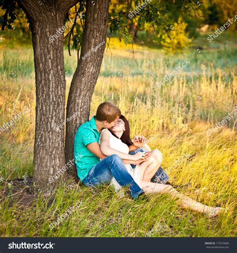 Young Couple Kissing Under Tree Stock Photo 173574668 Shutterstock