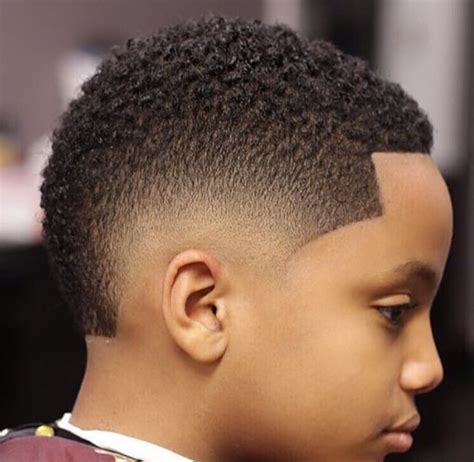 The shortest haircut represents a buzzed style with a few lined details. 65 Black Boys Haircuts 2019 - MrkidsHaircuts.Com