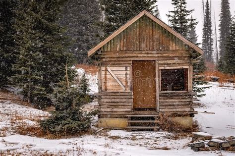 Cabin In The Remote Wilderness Of Idaho With Snow Falling Snow Flakes