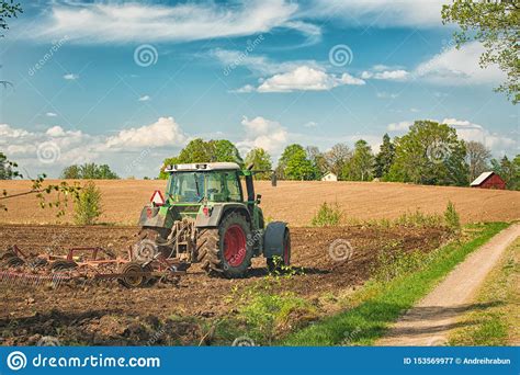Tractor Working On The Farm A Modern Agricultural Transport A Farmer