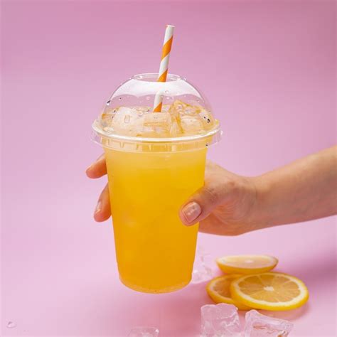 Premium Photo Fresh Lemonade With Oranges In A Plastic Cup