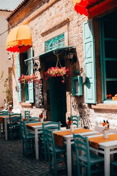 White Tables With Blue Chairs In An Empty Alfresco Area Of A Restaurant