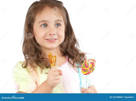 Happy Little Girl Holding Two Candies In Her Hands Stock Photo Image