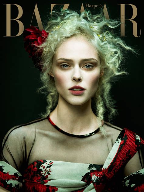 A Woman With Blonde Hair And Red Flowers In Her Hair On The Cover Of