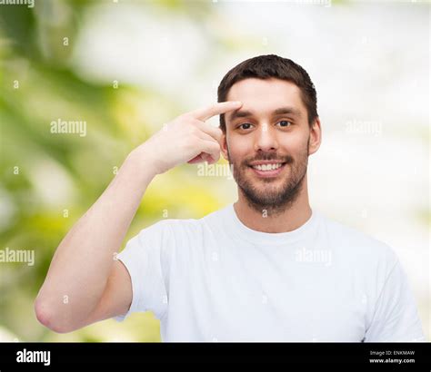 Smiling Young Handsome Man Pointing To Forehead Stock Photo Alamy