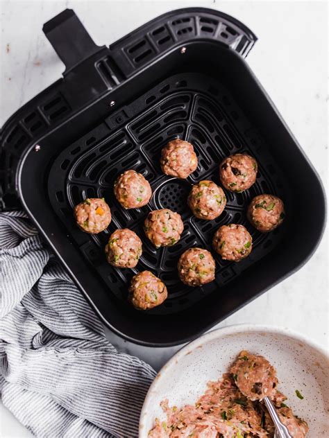 Add the marinara to your dutch oven, followed by the meatballs. keto asian meatballs-2 - Lenaskitchen
