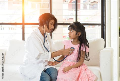 Indian Female Doctor Treating Young Girl Patient Stock Photo Adobe Stock