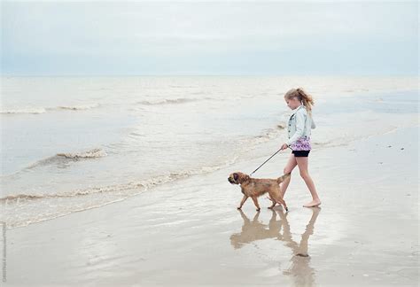 Girl And Her Dog Walking Towards The Sea By Christina K