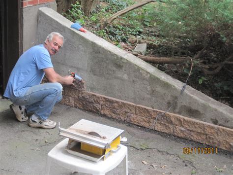 This is a very affordable outdoor bench that costs only $30 to build. Great way to cover up this unsitely cement wall and ...