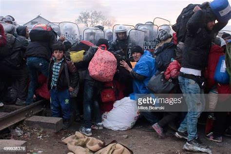 refugees take cover from rocks thrown at them by migrants from africa news photo getty images