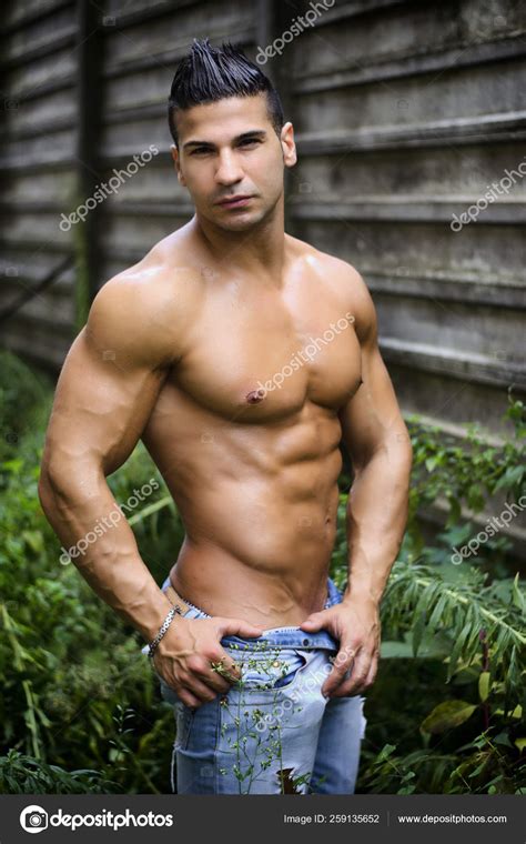 Muscular Young Latino Man Shirtless Jeans Front Concrete Wall Looking