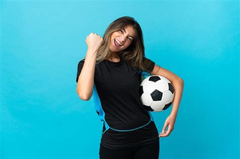 Premium Photo Young Football Player Woman Isolated On Blue Background