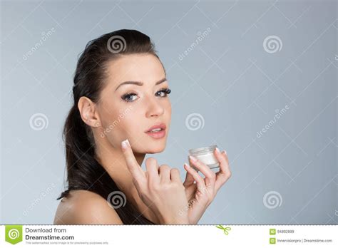 Young Beautiful Woman Applying Moisturizing Cream On Face Stock Image Image Of Cream